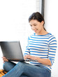 happy teenage girl with laptop computer