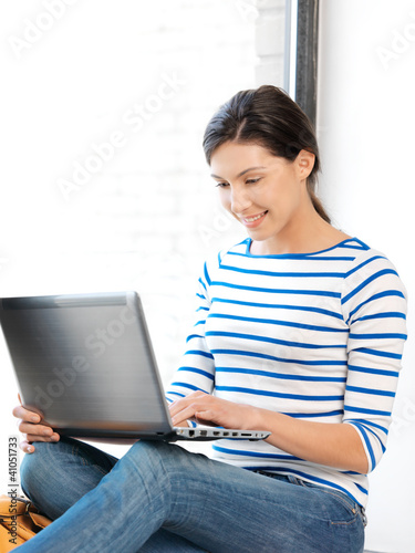 Photo: happy teenage girl with laptop computer happy teenage girl with laptop computer