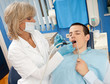 woman dentist with male patient