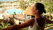 Видео: Young woman standing on terrace and enjoy beautiful view Young woman standing on terrace and enjoy beautiful view