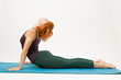 Red hair woman practicing fitness yoga