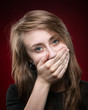 young woman covering the face with her hand