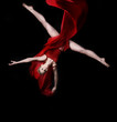 Foto: Young woman gymnast on black background Young woman gymnast on black background