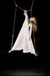 Young woman gymnast in white dress on rope Young woman gymnast in white dress on rope