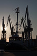 shipyard cranes and tugboat