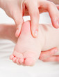 Mother massaging her baby
