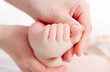 Mother massaging her baby