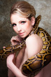 Attractive nude blond woman with python on grey Attractive nude blond woman with python on grey