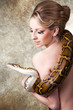 Photo: Attractive nude blond woman with python on grey Attractive nude blond woman with python on grey