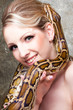 Attractive nude blond woman with python on grey Attractive nude blond woman with python on grey