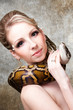 Attractive nude blond woman with python on grey Attractive nude blond woman with python on grey