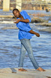 African American Dancer stretching on the rocks. African American Dancer stretching on the rocks.