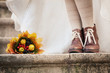 colorful autumn bouquet and two women legs with leather boots colorful autumn bouquet and two women legs with leather boots
