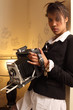 Photo: Beautiful female holding antique camera Beautiful female holding antique camera