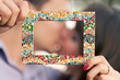 young couple holding a photo frame young couple holding a photo frame
