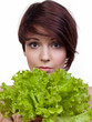 The girl is closed by salad sheet on a white background