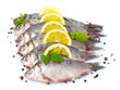 Fresh fishes with lemon, parsley and spice isolated on white Fresh fishes with lemon, parsley and spice isolated on white