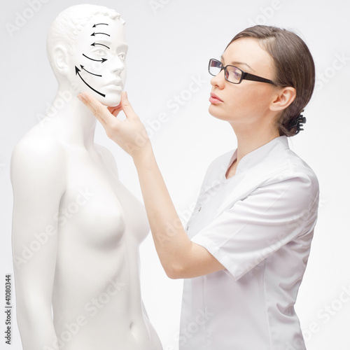 Photo: Female medical doctor student training with fake patient Female medical doctor student training with fake patient