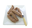 Pork sausages with caramelised red onions on white plate with kn Pork sausages with caramelised red onions on white plate with kn