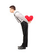 Man holding a red heart shape object and giving kisses Man holding a red heart shape object and giving kisses