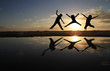 silhouette of kids jumping on beach in sunset silhouette of kids jumping on beach in sunset