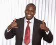 An african american businessman showing ok