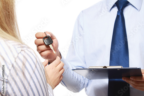 Photo: A male realtor giving keys to a woman A male realtor giving keys to a woman