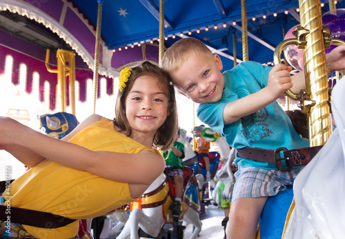 Photo: Kids having fun on a carnival Carousel Kids having fun on a carnival Carousel