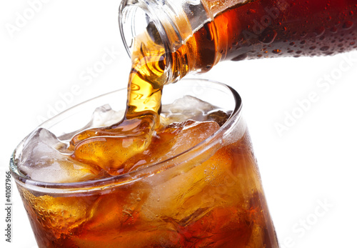 Photo: Cola is pouring into glass Cola is pouring into glass