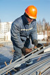builder works with concrete reinforcement