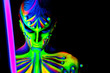 Man with fluorescent bodyart. Black background. Studio shot