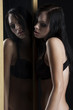 sexy woman in underwear next to a mirror