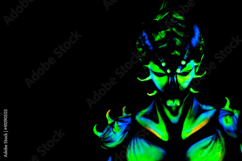 Photo: Man with fluorescent bodyart. Black background. Studio shot Man with fluorescent bodyart. Black background. Studio shot