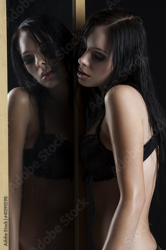 Photo: sexy woman in underwear next to a mirror sexy woman in underwear next to a mirror