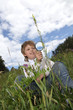 boy with magnifying glass outdoors