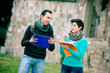 Two college students at park with books on hands Two college students at park with books on hands