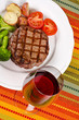 Barbecued Rib Eye Steak Served with a Glass of Red Wine