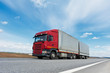Red lorry with grey trailer over blue sky