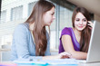 Two female college students working on a laptop computer during Two female college students working on a laptop computer during