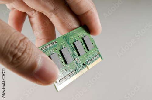 Photo: Hand holding DDR memory from notebook Technical support concept Hand holding DDR memory from notebook Technical support concept