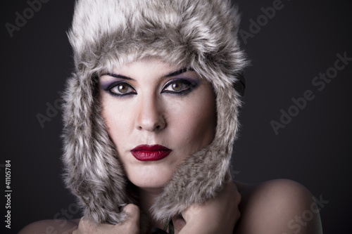 Photo: Russian Girl with hat on a dark background Russian Girl with hat on a dark background