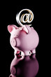 At symbol on piggy bank
