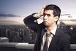 Photo: worried businessman on top of a building in NY city worried businessman on top of a building in NY city