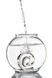 Foto: At symbol paperweight in a fishbowl with water pouring in At symbol paperweight in a fishbowl with water pouring in