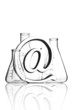 At symbol paperweight in front of flasks
