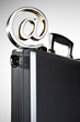 At symbol paperweight on a briefcase