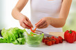 Photo: hand of a woman housewife preparing dinner, vegetables in kitche hand of a woman housewife preparing dinner, vegetables in kitche