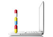Large pills on a laptop computer