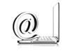 At symbol paper weight with laptop computer