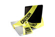 Laptop computer with caution tape wrapped around it